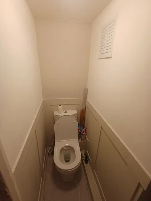 Refurbished cloakroom with painted wall panelling
