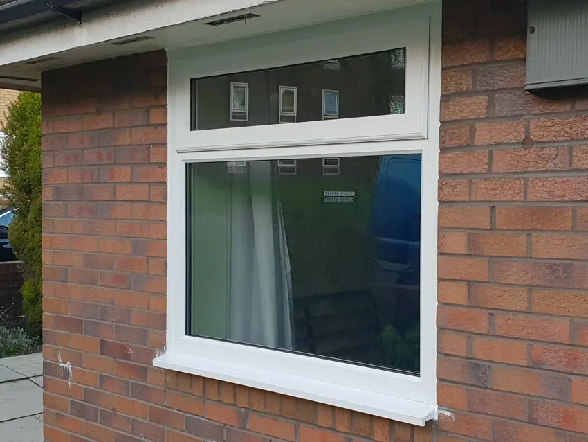 Completed white uPVC window fitted into brickwork