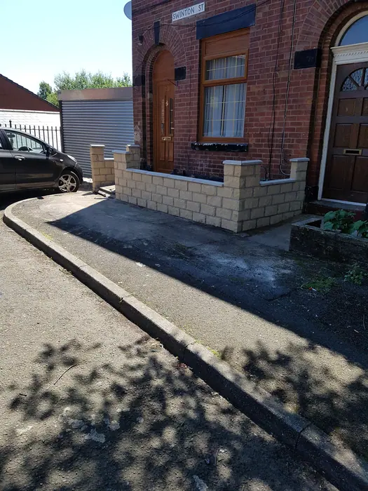 Finished garden wall beside brick house